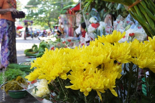 Yellow cut chrysanthemum bunch at street vendor retail at traditional local fresh market