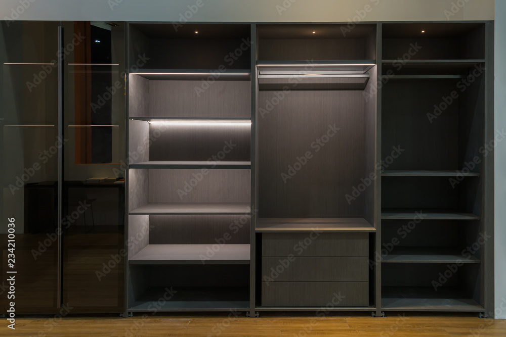 Modern brown empty wooden wall cabinet shelf interior with diffuse lighting in living room decoration contemporary. Modern brown empty wooden wall cabinet shelf interior with diffuse lighting in living room decoration contemporary.