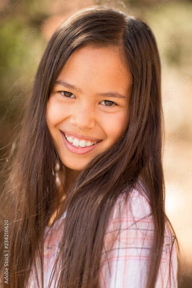 Portrait of a young asian girl smiling outside. Portrait of a young asian girl smiling outside.