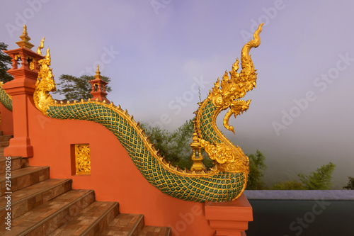 Beautiful Naga statue and arched entrance In the morning Before sunrisenat Wat Doi Phra Chan in Thailand temple
 photo