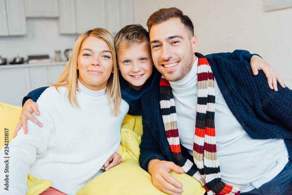 Fototapeta premium loving parents and smiling son looking at camera