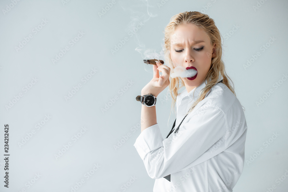 elegant blonde girl smoking cigar isolated on grey elegant blonde girl smoking cigar isolated on grey