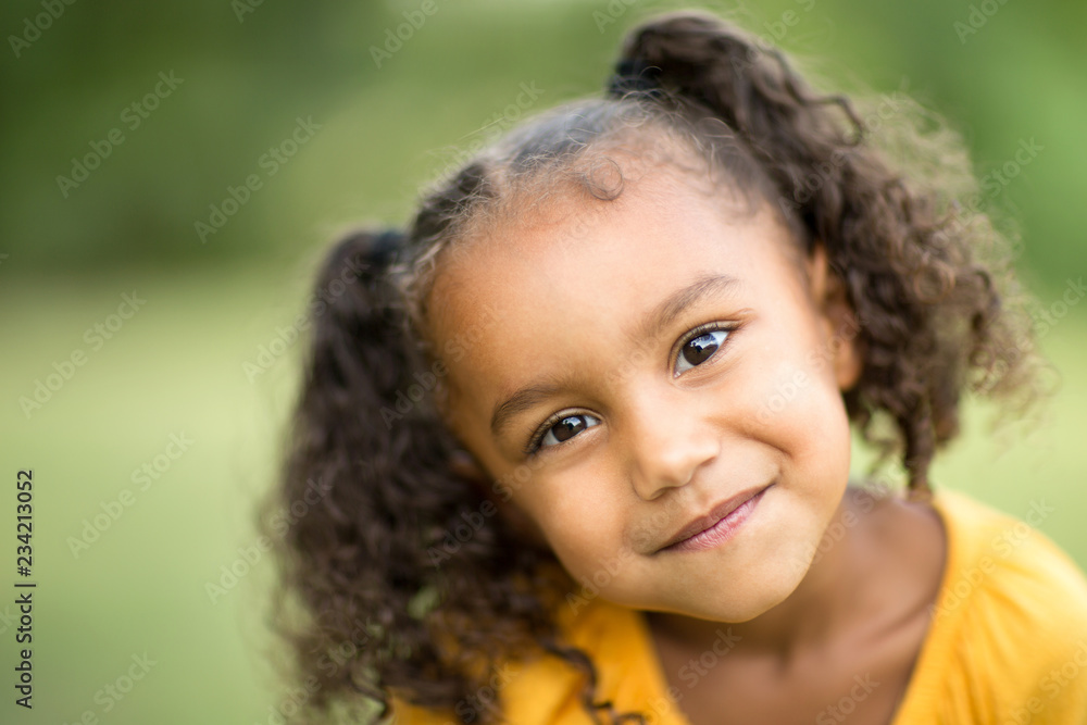 Cute mixed race little girl laughing and smiling. Cute mixed race little girl laughing and smiling.