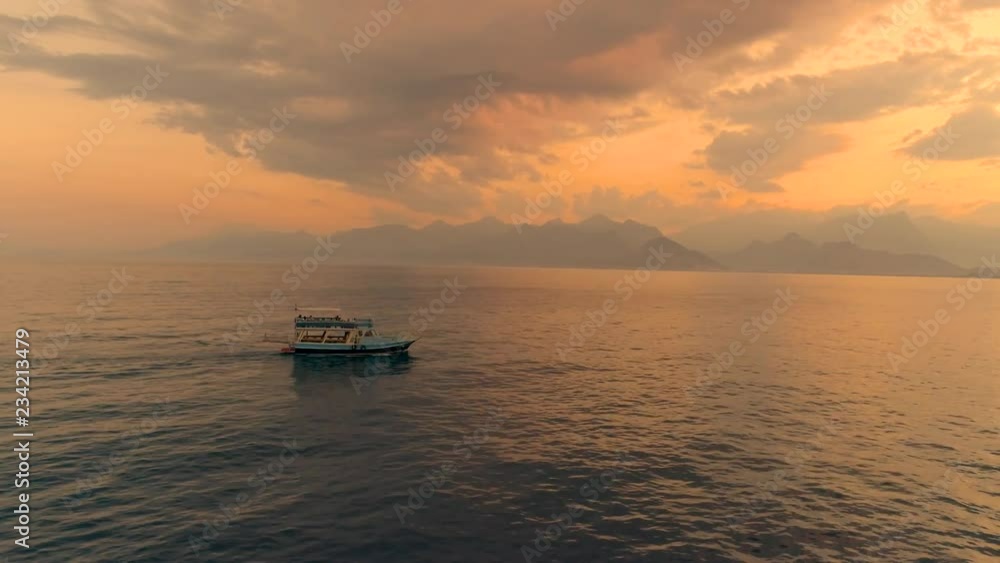 Aerial-Flying backwards from sightseeing boat on a cloudy sunset Aerial-Flying backwards from sightseeing boat on a cloudy sunset