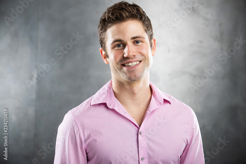 Happy man wearing a pink shirt