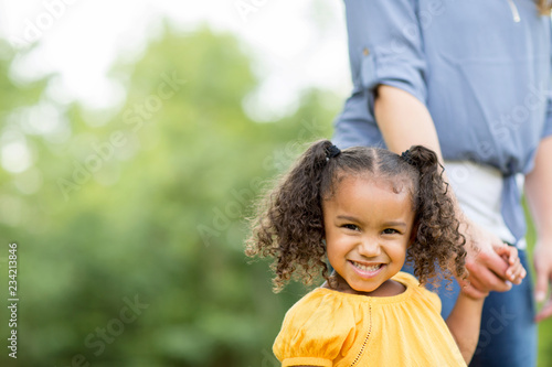 Mother and daugher laughing and playing at the park. photo