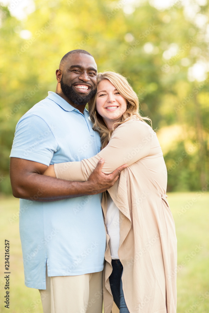 Fototapeta premium Loving mixed race couple hugging and laughing.