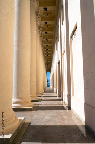 A long corridor between columns  perspective view. Collonade.