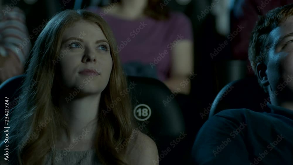 Attractive young woman at the cinema watching a movie. Attractive young woman at the cinema watching a movie.