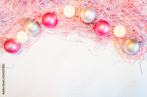 New Year's still-life, on which is placed the orthodox multi-colored paper and plain Christmas-tree decorations. Image in delicate silvery-pink tones.