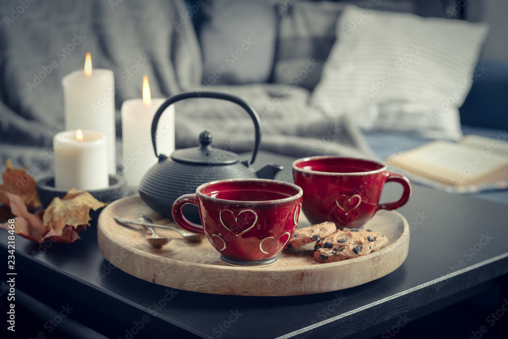 Two cups of tea on a serving tray on coffee table. Two cups of tea on a serving tray on coffee table.