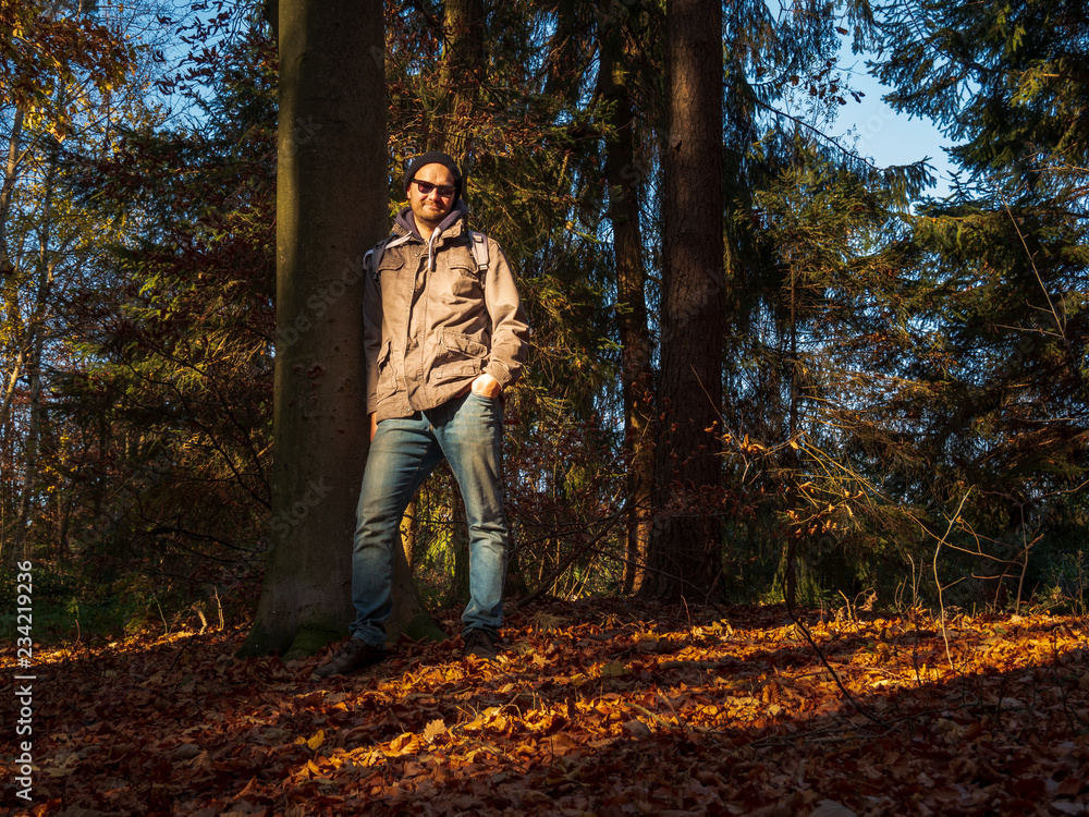 Outdoor Man Model in forest with Autumn Sun Outdoor Man Model in forest with Autumn Sun
