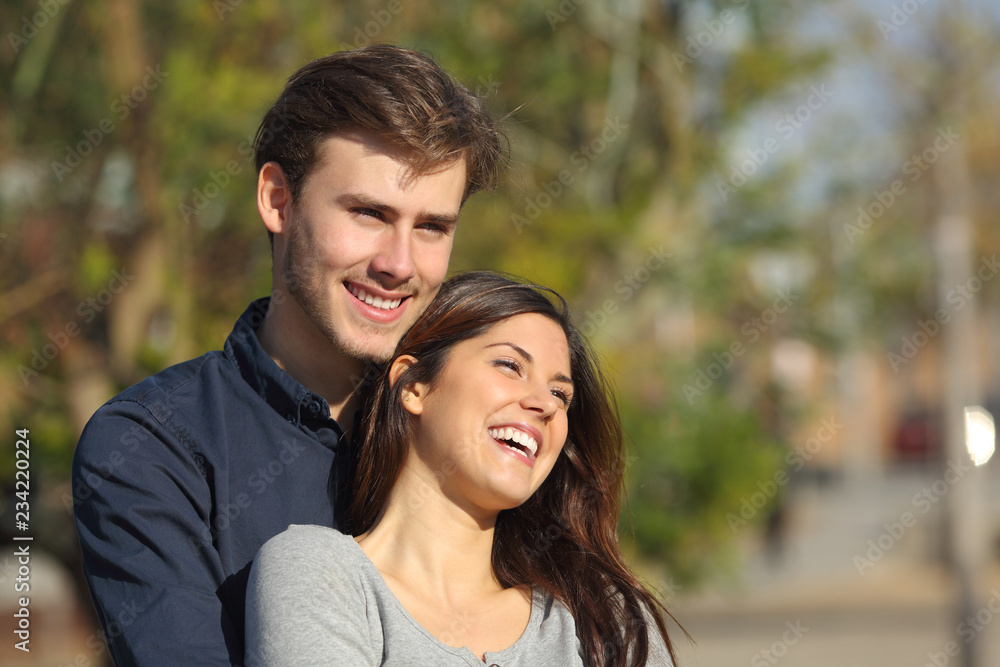 Couple flirting looking away in a park Couple flirting looking away in a park