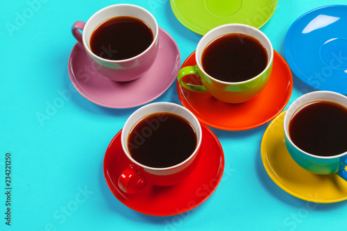 Colorful coffee cups and saucers on colorful vibrant background