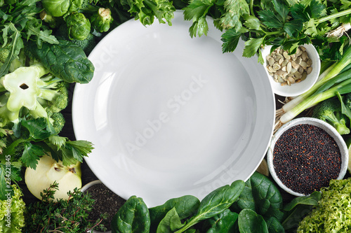 Empty white plate vegetables fruit herbs superfood top view Healthy food ingredients background