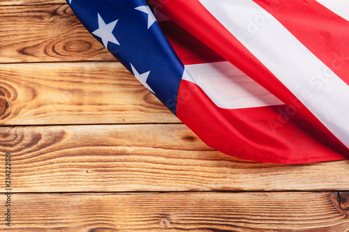 USA flag on light wooden table background close up copy space