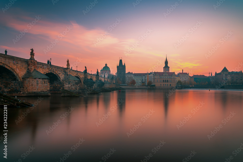Beautiful sunrise panoramic view over Charles Bridge on Vltava River and old historical town in Prague, Czech Republic, Europe Beautiful sunrise panoramic view over Charles Bridge on Vltava River and old historical town in Prague, Czech Republic, Europe