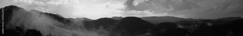 Mountain panorama with a dramatic sky background