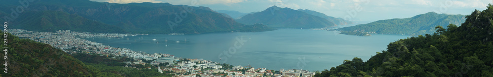 Nature landscape with a city by the shore of the sea between the hills. mountain town panorama
