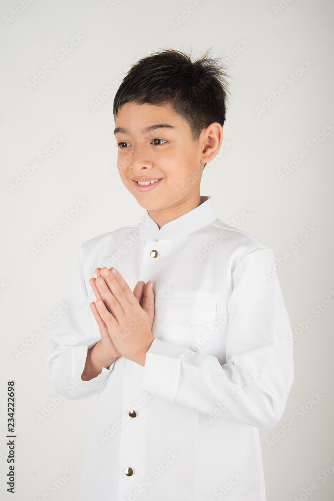 Little asian boy praying in Thai costume isolate on white background Little asian boy praying in Thai costume isolate on white background