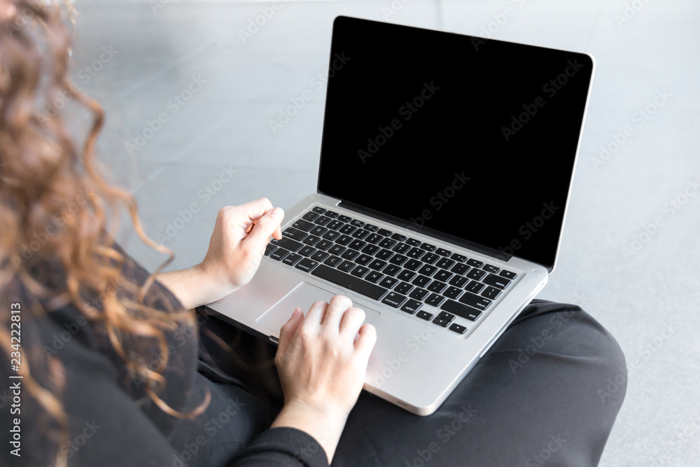 Beautiful woman with curly hair dressed on black working or shopping using computer or tablet Beautiful woman with curly hair dressed on black working or shopping using computer or tablet