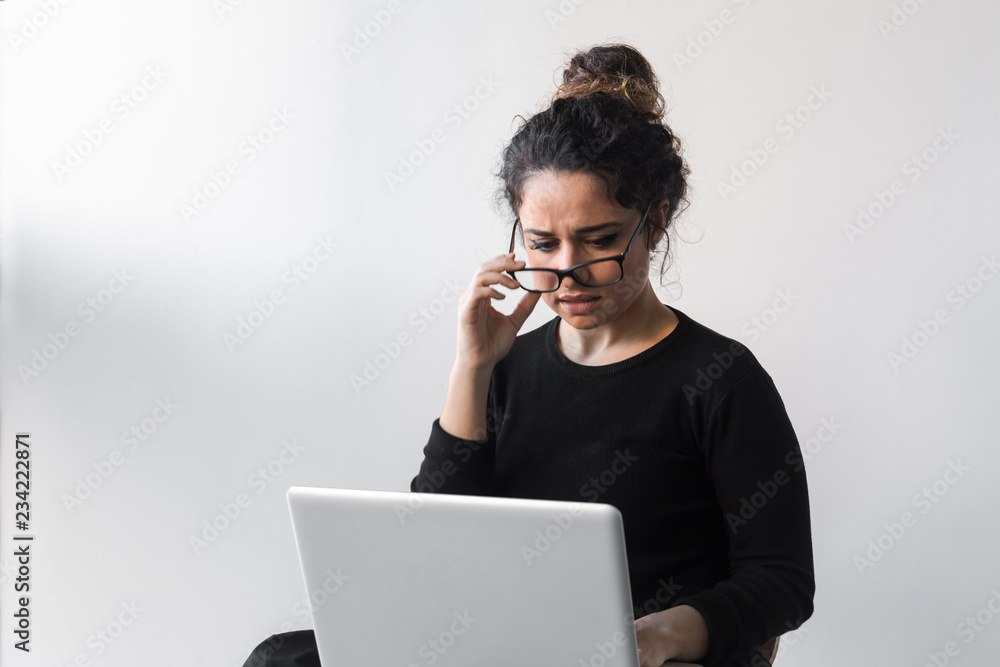 Beautiful woman with curly hair dressed on black working or shopping using computer or tablet Beautiful woman with curly hair dressed on black working or shopping using computer or tablet