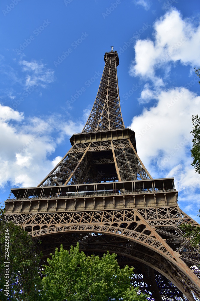 Eiffel Tower, Paris, France. Perspective from below with trees. Eiffel Tower, Paris, France. Perspective from below with trees.