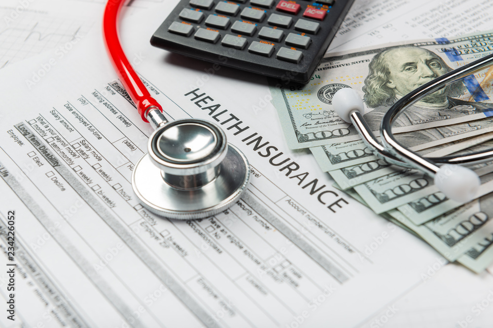 Health insurance application form with banknote and stethoscope concept Health insurance application form with banknote and stethoscope concept