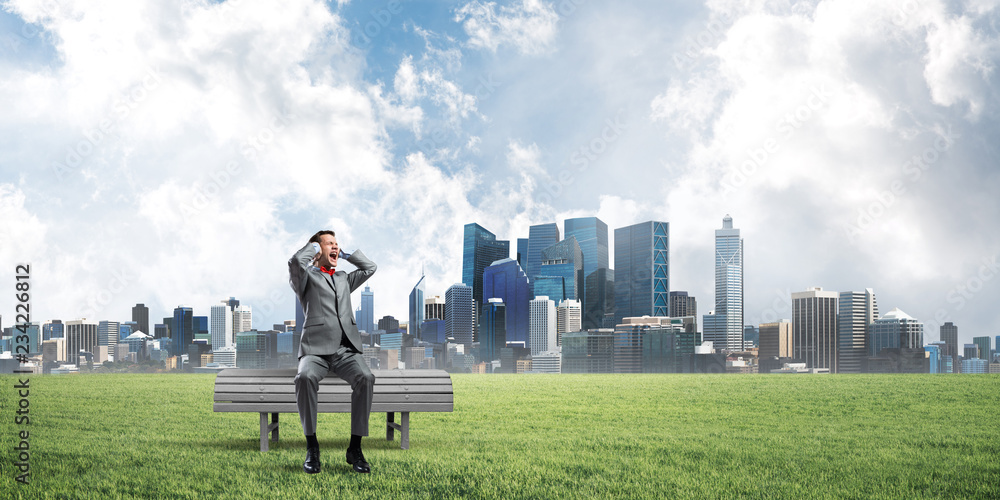 Young man in suit in park dont want to hear anything Young man in suit in park dont want to hear anything