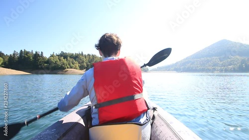     Kayaking on lake Lokve, young active woman on the Lokvarsko lake in Gorski kotar, Croatia. Girl enjoying adventurous experience on a sunny day.  photo