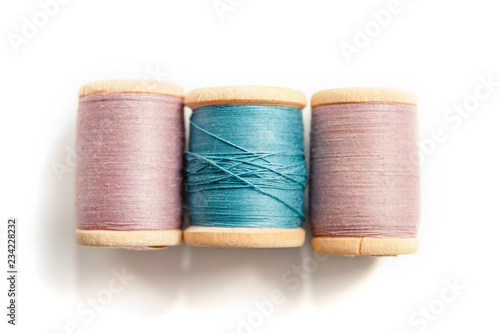 spool of thread isolated on white background in soft focus, sewing supplies and accessories for needlework, multicolored thread coils for sewing clothes