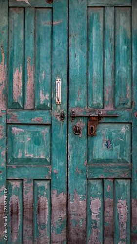 Closed old wooden door with open lock. Vintage