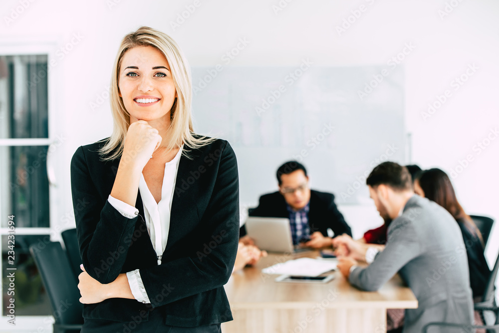 businesswoman manager standing smile with business team working together in office background. businesswoman manager standing smile with business team working together in office background.