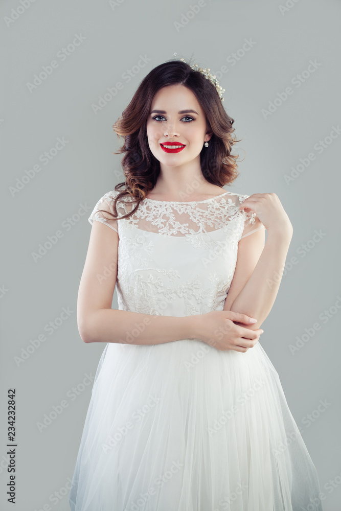 Happy woman in white wedding dress. Perfect brunette bride portrait