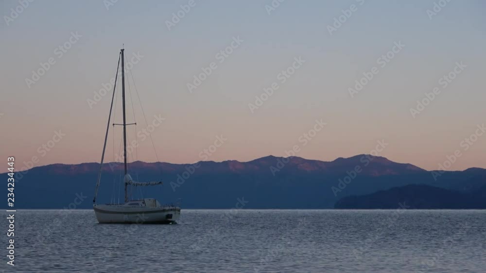 Time lapse of sunrise with a sailboat on Lake Tahoe Time lapse of sunrise with a sailboat on Lake Tahoe