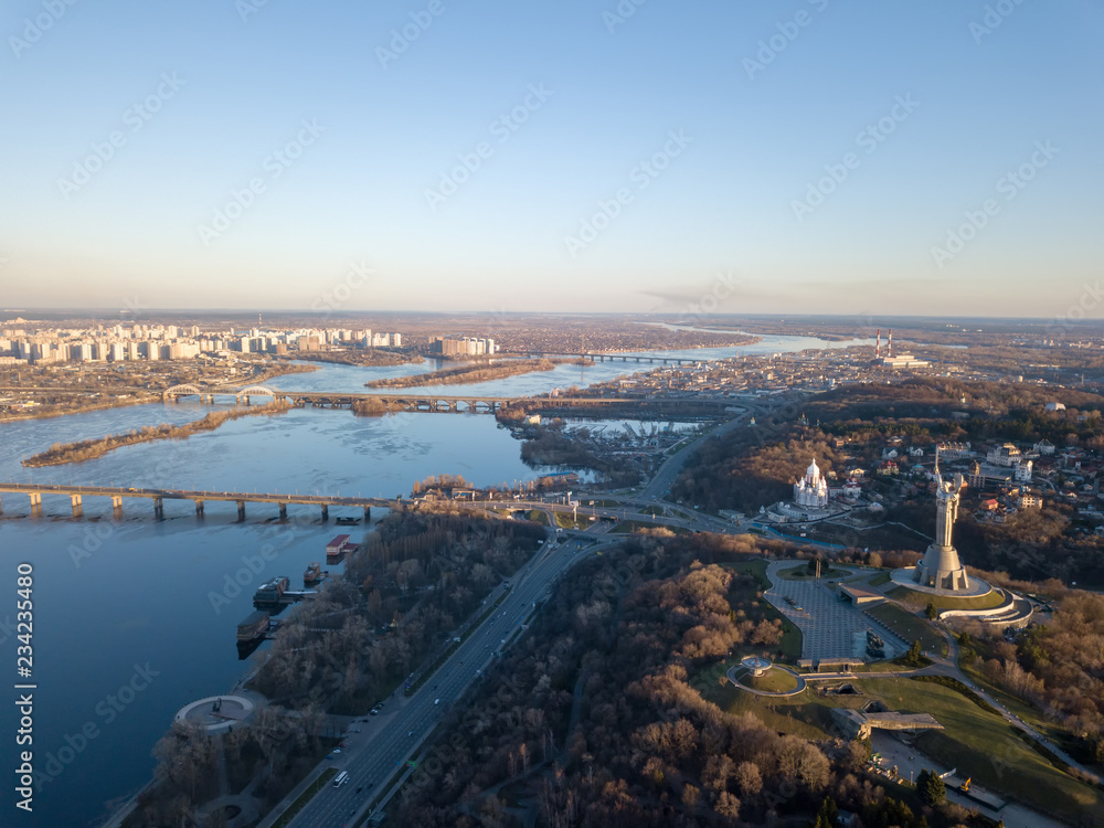Fototapeta premium Beautiful urban landscape on the left, right banks of the Dnieper, Kiev, Ukraine, modern architecture against the blue sky on a sunny spring day