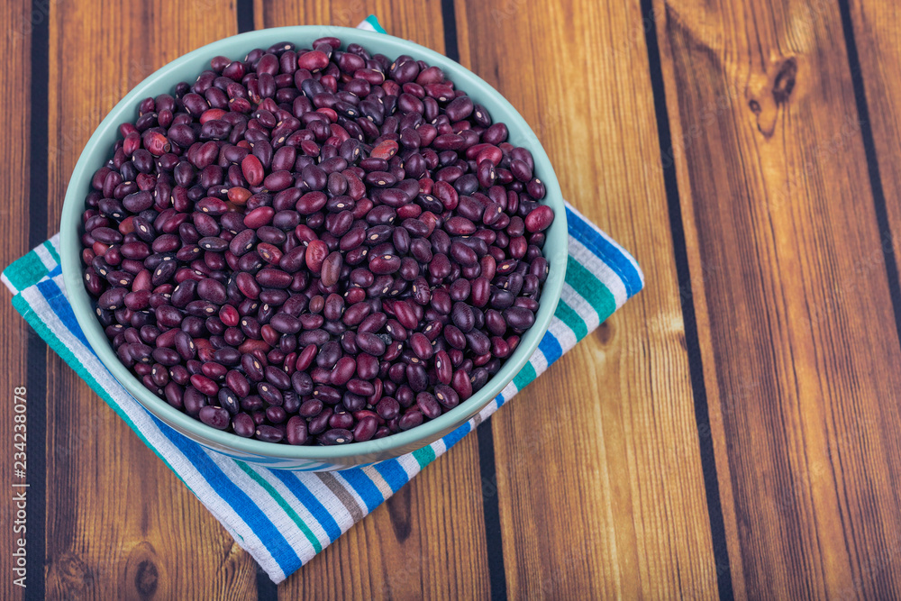The concept of natural healthy food. Plate with grains of red beans closeup The concept of natural healthy food. Plate with grains of red beans closeup