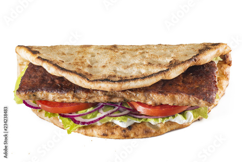 Greek pita with meat, salad, tomato and sauce isolated on white