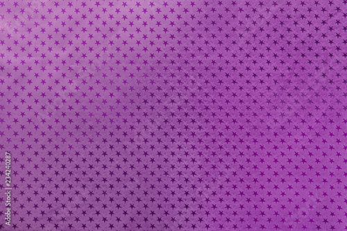 Dark purple background from metal foil paper with a stars pattern