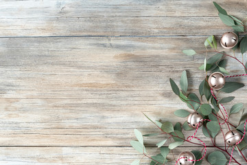 Christmas composition. X-mas card. New Year card. Winter holiday eucalyptus on wooden modern background. Flat lay, top view, copy space