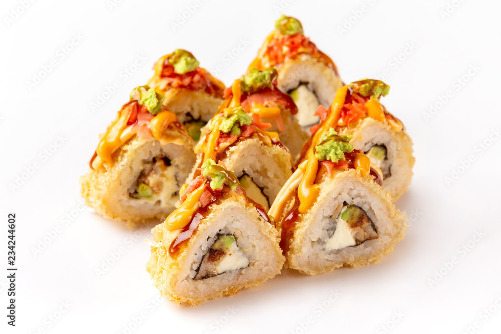 Hot tempura sushi rolls with eel, avocado and cream cheese served with teriyaki sauce isolated at white background. Hot tempura sushi rolls with eel, avocado and cream cheese served with teriyaki sauce isolated at white background.