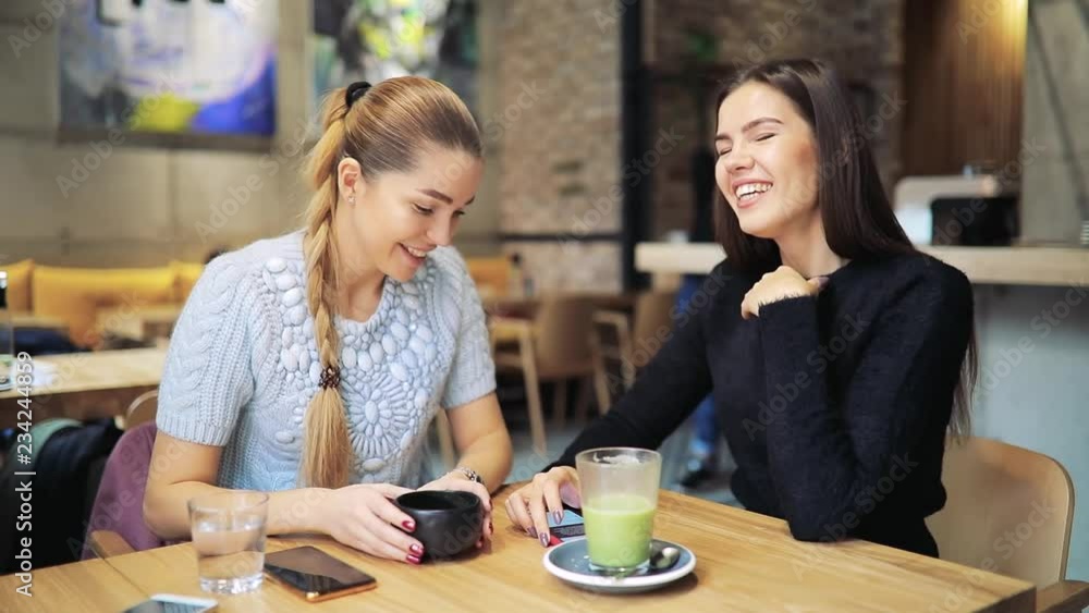 Women friends talking in a cafe drinking matcha, healthy food Women friends talking in a cafe drinking matcha, healthy food