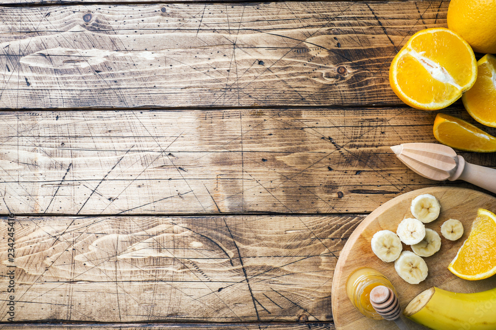 Pieces of fresh orange juice on wooden background. Copy space. Pieces of fresh orange juice on wooden background. Copy space.