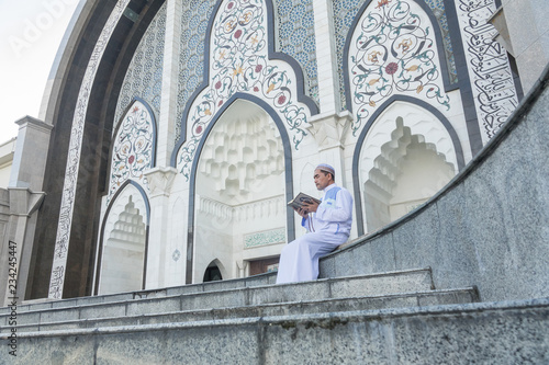 Middle age muslim man praying at mosque. photo