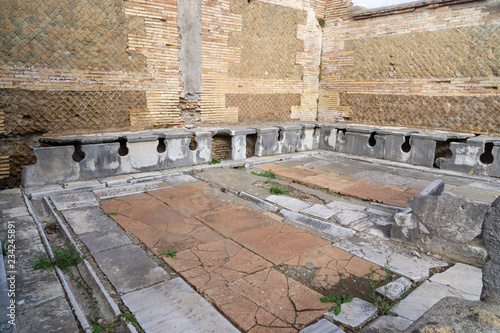 Ostia antica in Rome, Italy. Roman public latrine found in the excavations of Ostia Antica; unlike modern installations, the Romans saw no need to provide privacy for individual users.