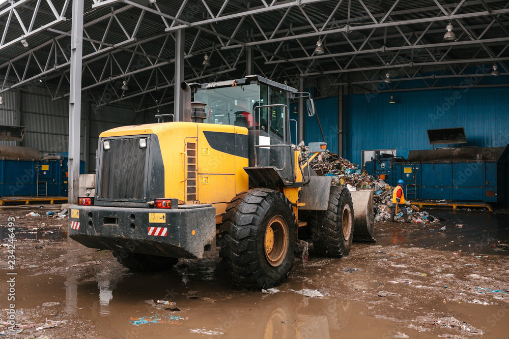 Special machinery or bulldozer work on the site of waste unloading at the plant for waste disposal. Technological process. Business for sorting and recycling. Special machinery or bulldozer work on the site of waste unloading at the plant for waste disposal. Technological process. Business for sorting and recycling.