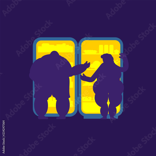 Open fridge night and fat Married couple. Food silhouette. Refrigerator for glutton