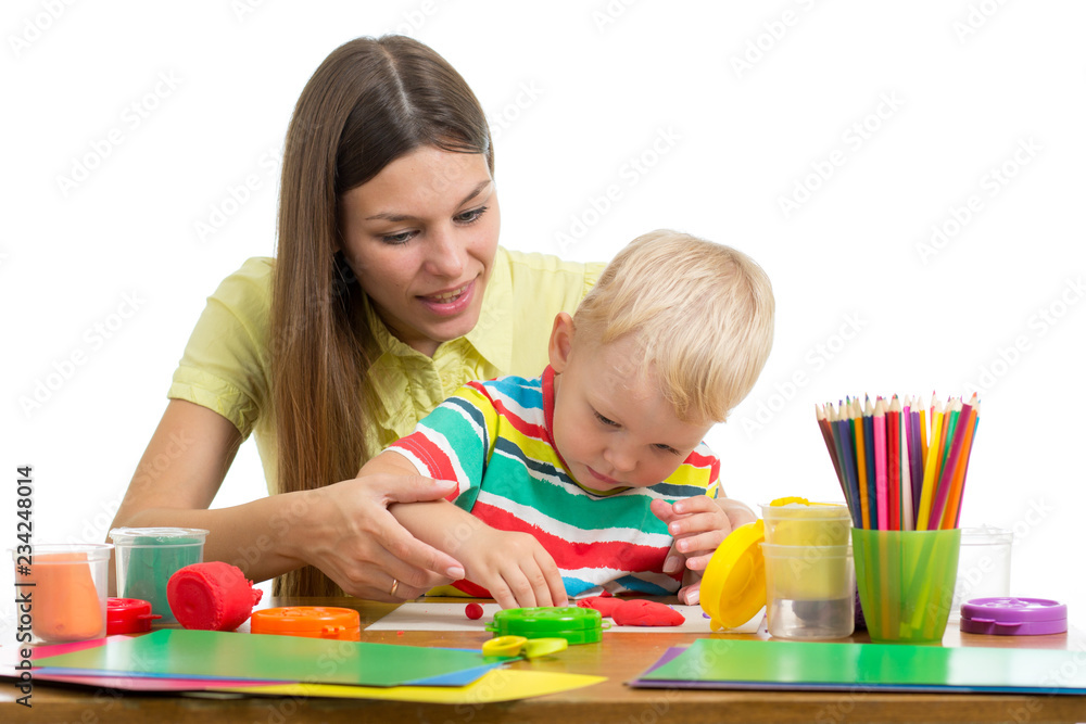 Cute woman and kid boy playing plasticine toys at home Cute woman and kid boy playing plasticine toys at home