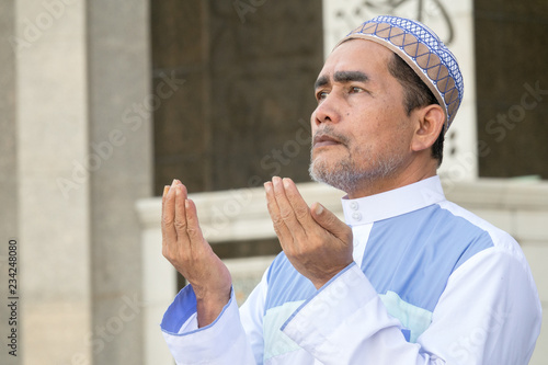 Middle age muslim man praying at mosque. photo