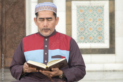 Middle age muslim man praying at mosque. photo